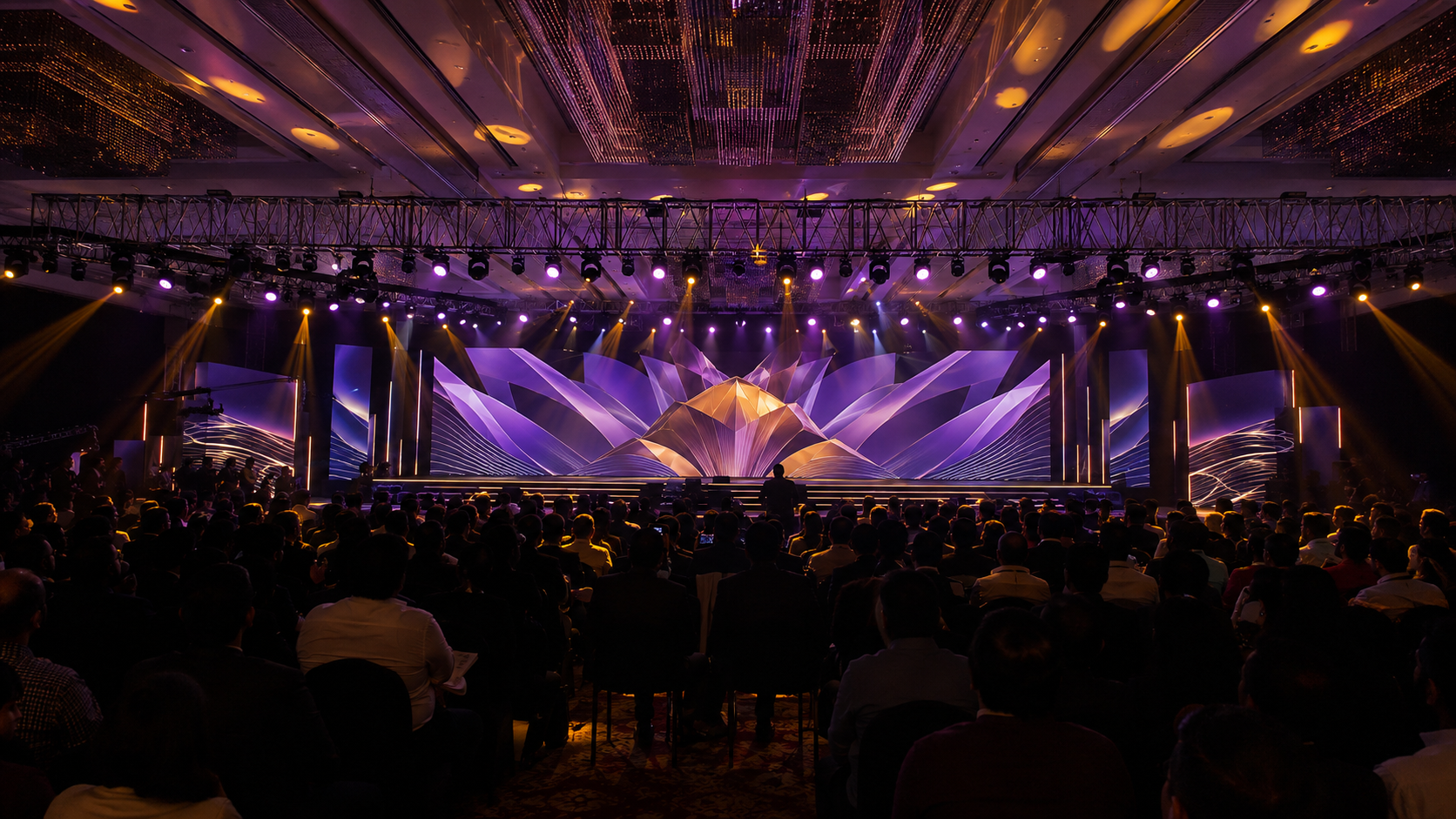A corporate launch stage with an audience, theatrical lighting and a large screen